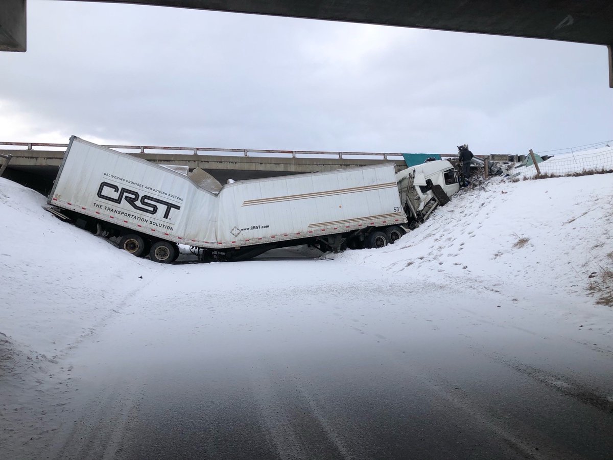 A semi slid off I-90 and is underneath the bridge at Fort Ellis Road, the overpass is blocked