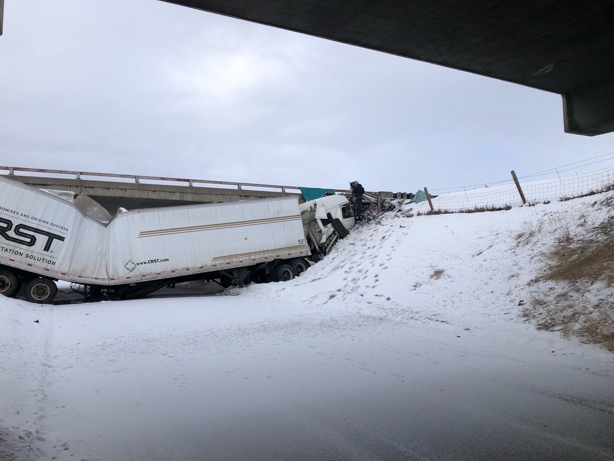 A semi slid off I-90 and is underneath the bridge at Fort Ellis Road, the overpass is blocked